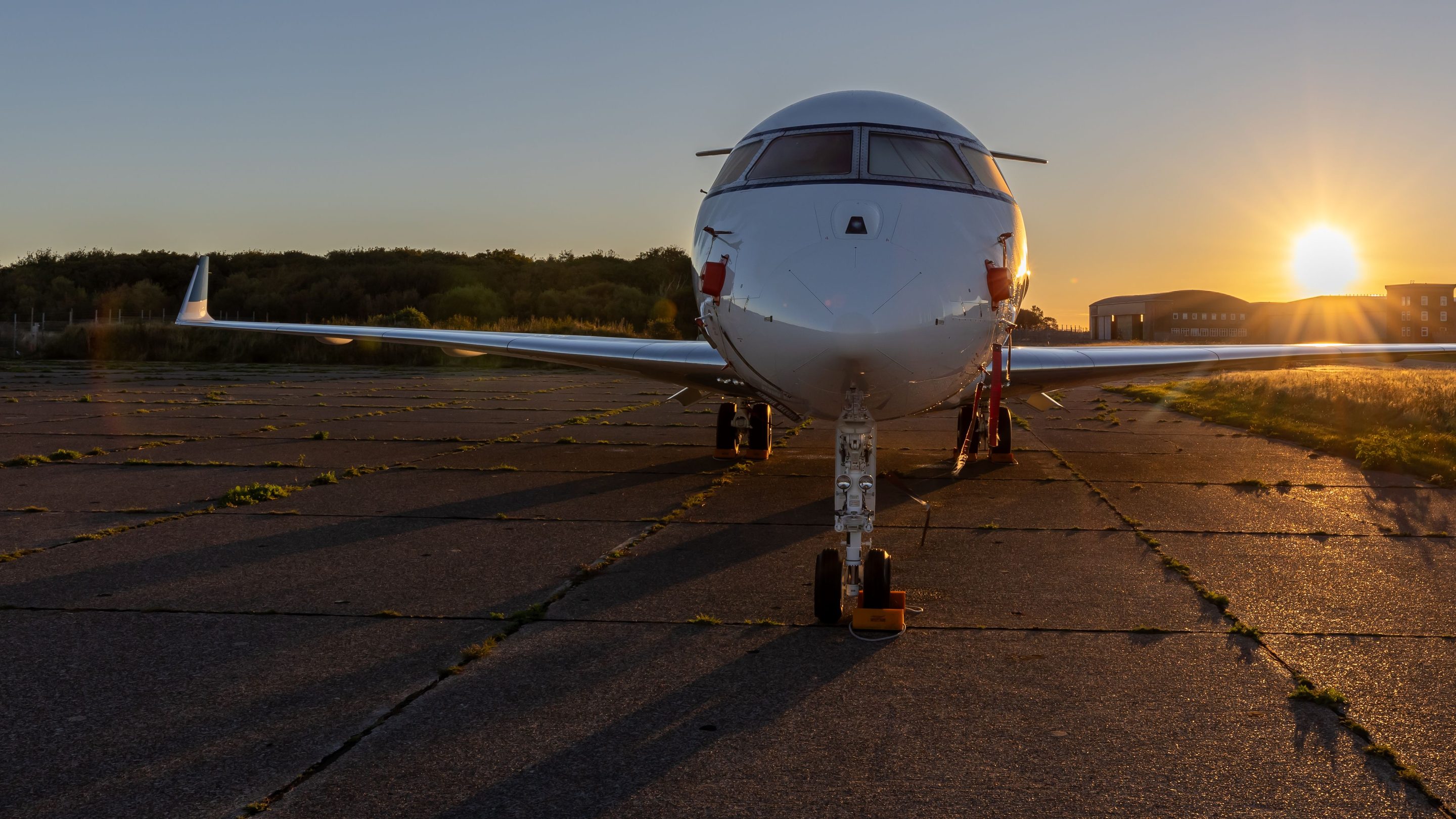 A private jet on the apron at sunset, seen head-on. Stock photograph, not a TM Aviation aircraft.