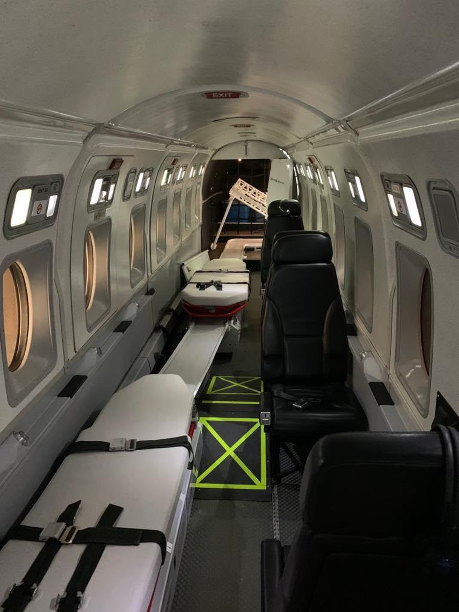 Dual stretchers and seats in the cabin of a Beechcraft 1900D air ambulance, looking aft