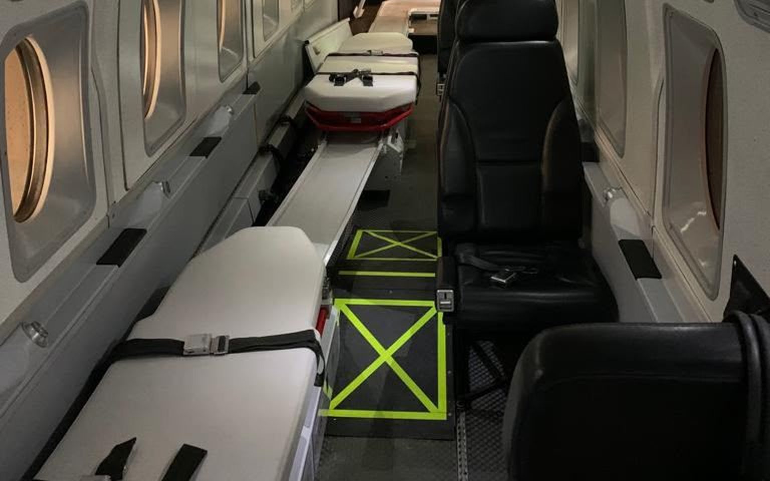 Two patient stretchers and crew seats along the cabin of a Beechcraft 1900D air ambulance